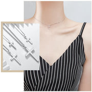 Delicate silver cross necklace worn by woman in black striped dress women's faith jewelry by Fresh Faith Designs