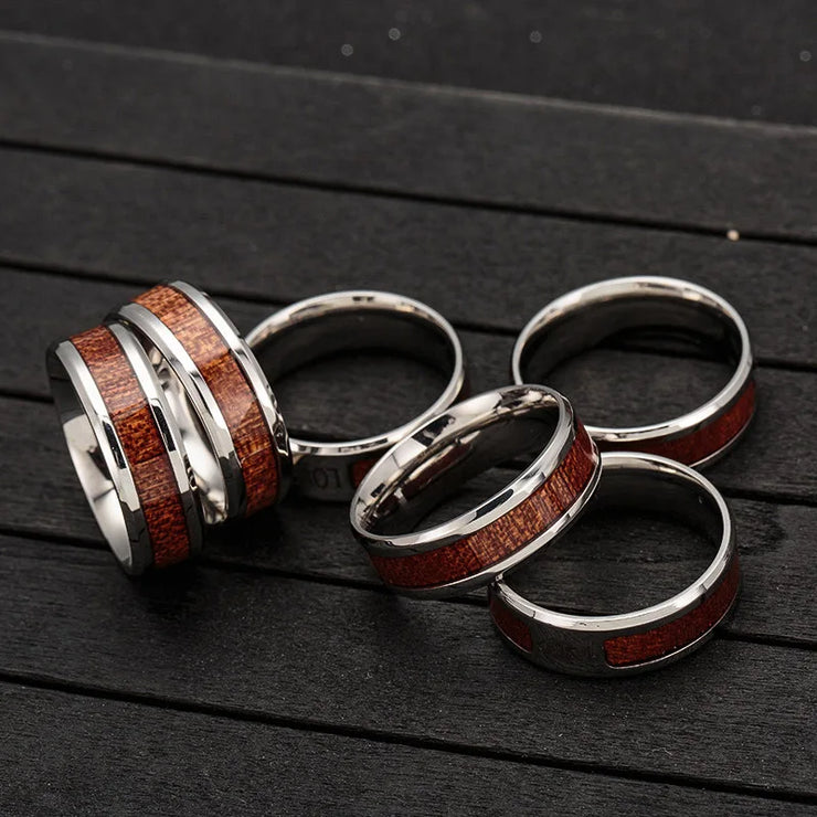 Fresh Faith Designs men's Christian jewelry featuring silver rings with wood inlay on black surface